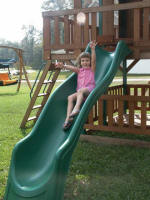 Alana enjoys the sliding board in her backyard in Conway.