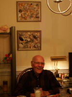 Daddy seated in front of some of his shell pictures.