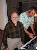 Daddy likes playing George's new keyboard.
