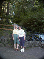 Mother & Daddy in front of the "tiered" falls on Wahkeena Creeknot a sheer drop, but the waters hurl themselves over a series of fantastic cascades down a steep declivity.