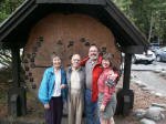 Mother, Daddy, Joe, and Ruth in front of the cross-section of the Douglas-fir, sprouted in 1293, cut 697 years later.