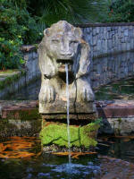 Mossy-based spouting lion fountain.