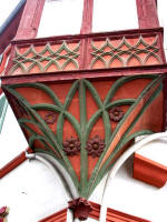 Close-up of a colorfully adorned bartizan (a small, overhanging turret on a wall or tower) on Main Street (seen in the above photo).