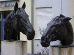 Life-size bronze horse portraits, "Maja" 1975 & "Gajo" 1987, Carrara marble on cement stela, at the historical 1742 Hesselgasse Postal stop; erected 2007; donated by the family of Dr. Helmut Bergdolt, Wiesloch.